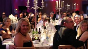 Simply Waste Solutions summer charity ball, people on tables with one woman smiling towards the camera