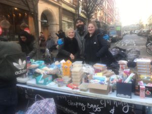 Street Angels UK team behind table with food for homeless on