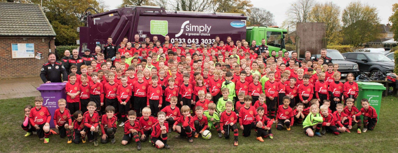 Flackwell Heath Minors FC (FHMFC) wearing Simply Waste Solutions' sponsored kits in front of a trade waste truck