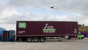 Simply Waste Solutions artic truck in Stanwell depot with plane flying over