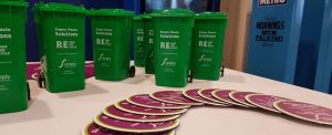 Recycling roadshow at Ealing Broadway station. Simply Waste Solutions wheelie bin posts and coaster merchandise on table