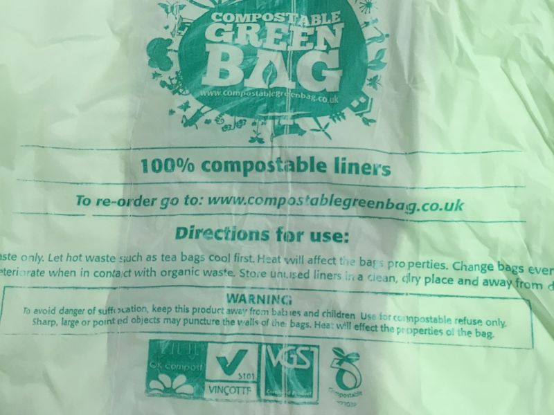 Compostable green bag with compostable recycling symbol