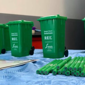 Recycling Roadshow at Banbury Station. Simply Waste Solutions merchandise of pencils and wheelie bins placed on table.