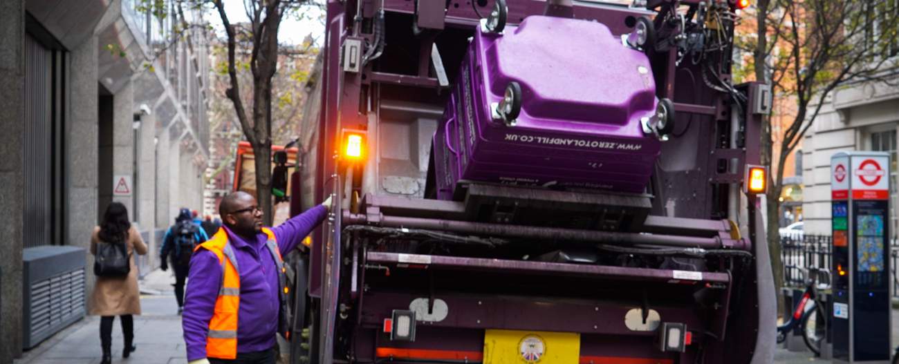 Simply Waste Solutions driver tipping wheelie bin into trade waste truck
